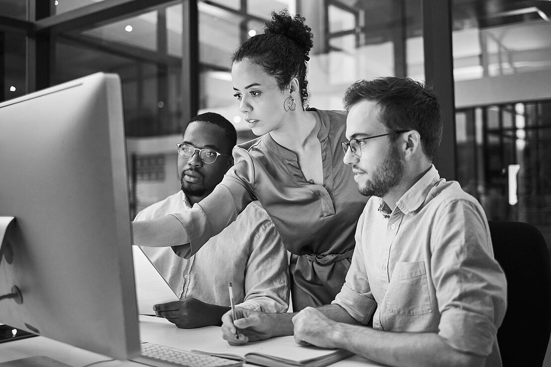 3 people in front of computer